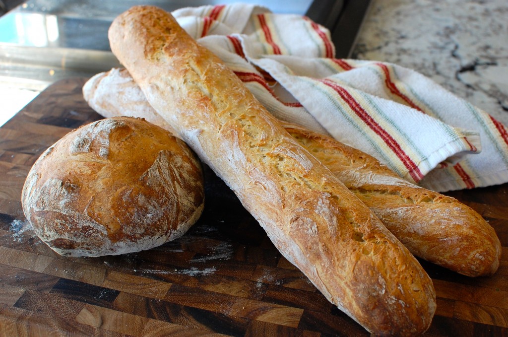 Fresh Homemade Artisan Bread On A Cutting Board With Tea Towel And